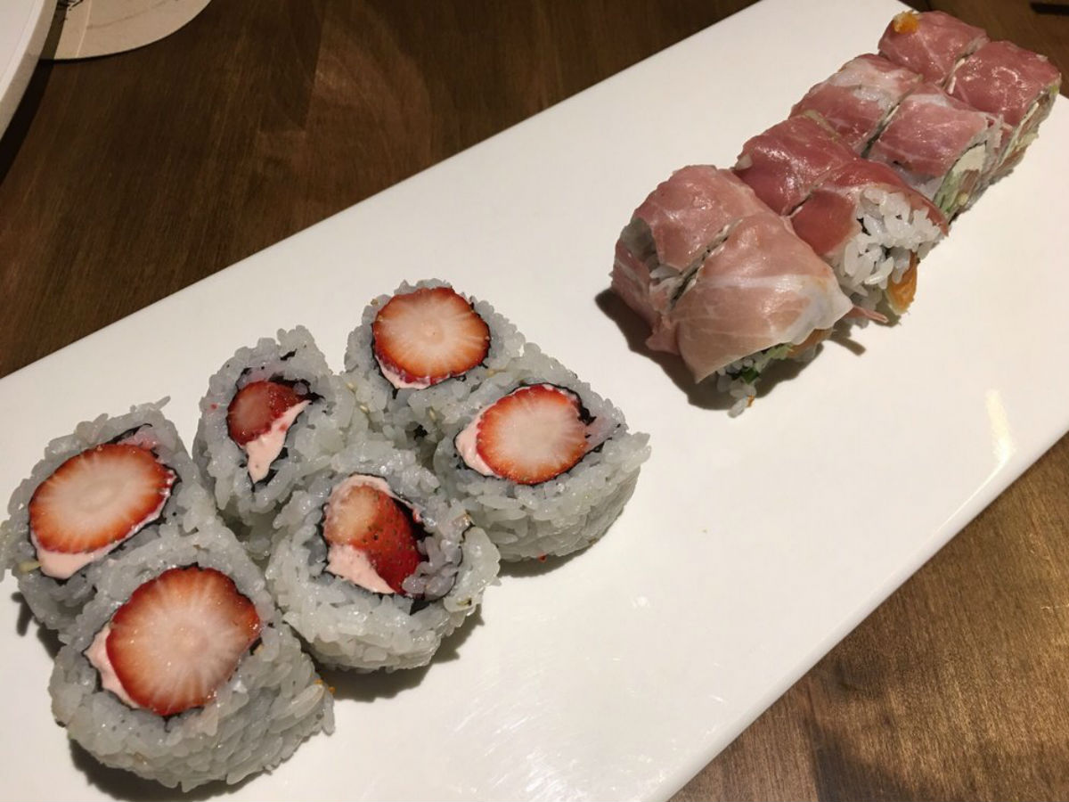Sushi Kuni: Bento box lunch spot - Shrimp tempura and masago caviar. Rolled uramaki style. Wrapped with tuna, avocado and strawberry. Topped with Las Vegas and Kiwi Lime sauce