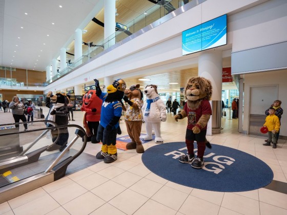 Five ways to celebrate Tourism Week in Winnipeg - Mascot Madness in front of the 'Hug Rug' at the Winnipeg Airport (photo Abby Matheson)