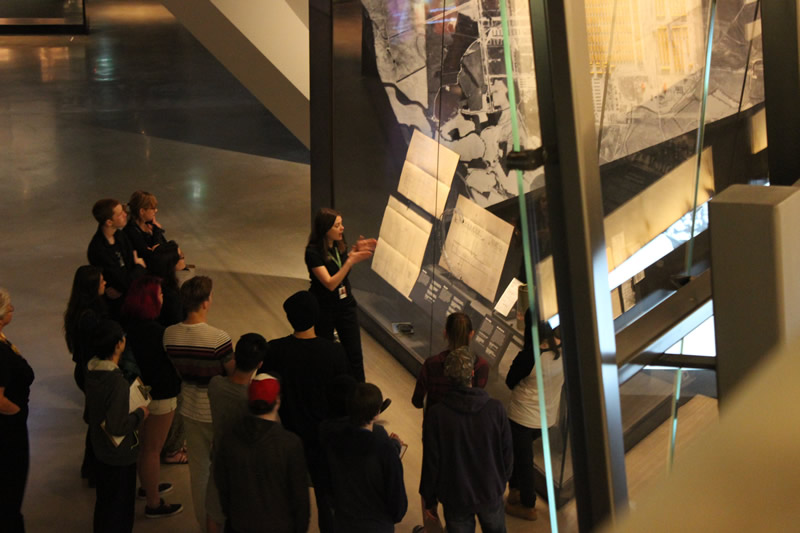 A museum guide pointing out details in the Examining the Holocaust gallery (Tourism Winnipeg)