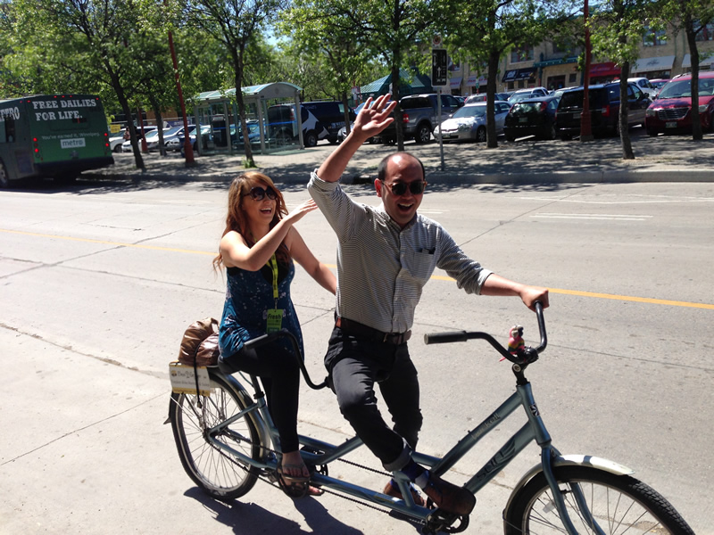 991 Fresh Radio's Vicki Shae and Downtown Biz' Jason Syvixay riding in style (Tourism Winnipeg)