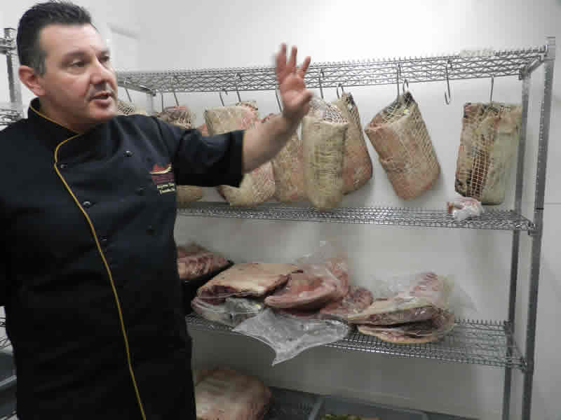 Prairie 360˚'s executive chef Alfonso Maury inside the dry-aging room. 