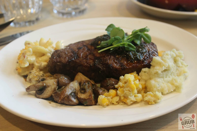 New York steak with creamed corn (right), grilled garlic mushrooms and mac and cheese at Smith. 