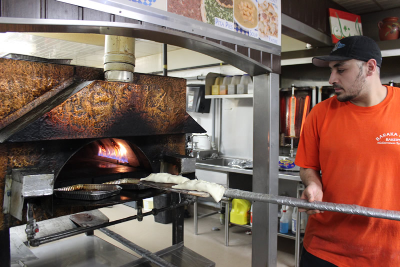 Chef Rami Aboumrad of Baraka holds court over the natural gas oven (PCG)