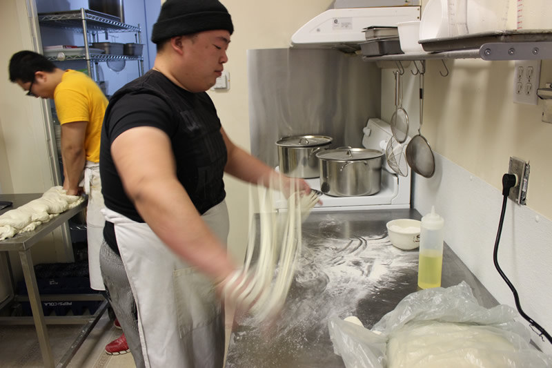 Dancing Noodle chef/owner Xiaofei Zuo hand-pulling la mian noodles (PCG)