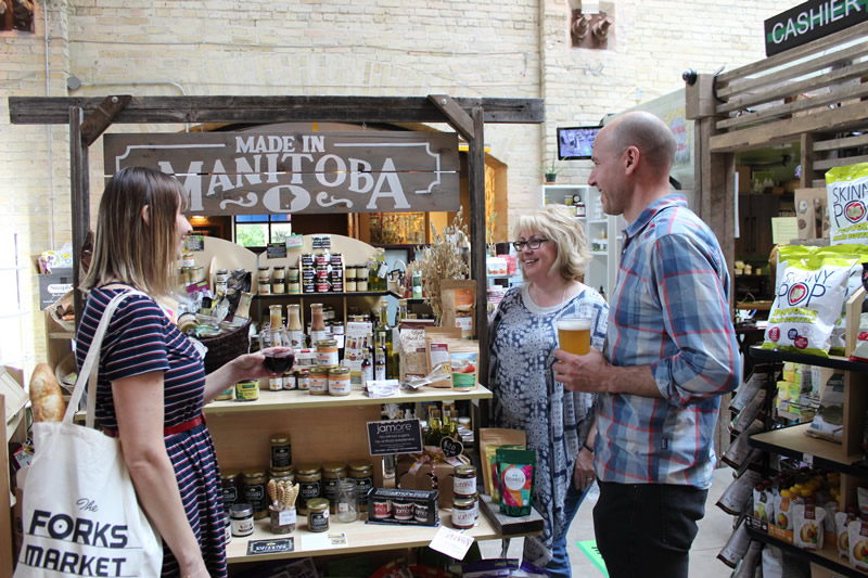 Chelsea Thompson and Dave Pancoe from the Forks (with drinks in hand) just loving life as they shop the Forks Market (PCG)